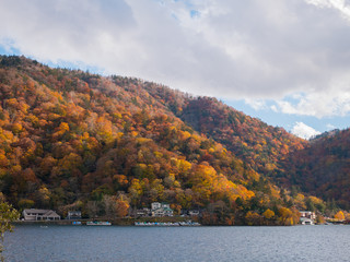 Mountain forest and lake in autumn season.