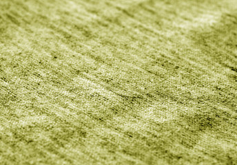 Textile texture with blur effect in yellow tone.