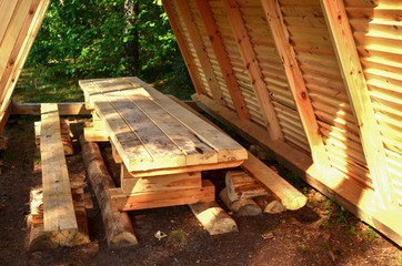 Wooden house, hut in the forest for tourists, fishermen and hunters for rest and cooking. Republic of Belarus. River "Bobr". Natural landscape scenery © MaxSafaniuk