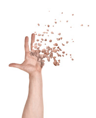 Close-up of man's hand with fingers and palm starting to dissolve into pieces isolated on white background.
