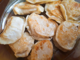 Fried Russian dumplings. A delicious dish on a plate. Ruddy dumplings. Delicious ready and traditional Polish dinner.