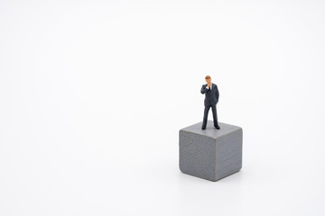 Miniature people businessmen standing on Wooden cube Investment Analysis Or investment Blockchain concept. as background business concept and strategy concept with copy space.