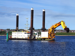 Backhoe Dredger maneuvering onto dredging position.