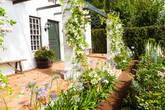 Garden landscape with flowerbed and entrance area