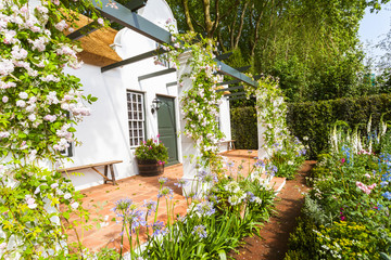Garden landscape with flowerbed and entrance area