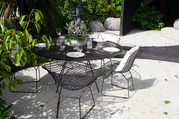 Patio area with a served table in a beautiful garden