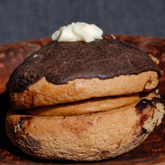 Cake with nut filling and chocolate icing in a plate. Shallow depth of field