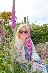 middle aged woman among wild fox gloves