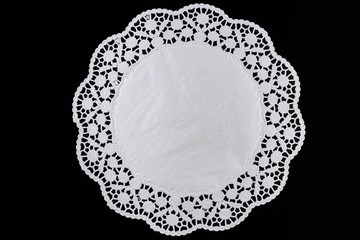 White paper round lace doily, on black background. - obrazy, fototapety, plakaty