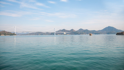 Beautiful landscape of the Seto Inland Sea and Innoshima Bridge in the background which connects Mukoujima Island and Innoshima Island in the Shikoku Region of Japan, famous for the Shimanami Kaido.