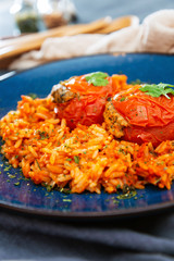 stuffed tomatoes with rice on a white plate
