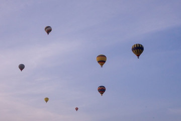 Hot air balloon flying over rock landscape at Cappadocia Turkey