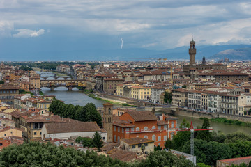 Fototapeta na wymiar Panaromic view of Florence townscape cityscape viewed from Piazzale Michelangelo (Michelangelo Square) with ponte Vecchio and Palazzo Vecchio with lightning