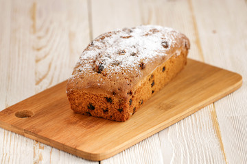 Delicious homemade cake with raisins on a light wooden background. close-up. rustic. copy space.