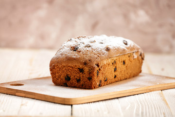 Fototapeta na wymiar Delicious homemade cake with raisins on a light wooden background. close-up. rustic. copy space.