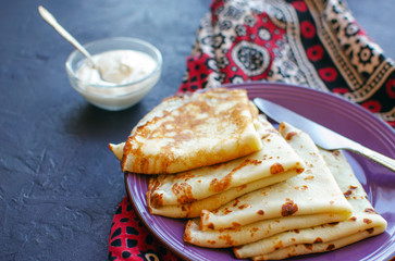 Stack of homemade thin pancakes or crepes or pancake cake, selective focus.