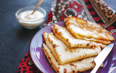 Stack of homemade thin pancakes or crepes or pancake cake, selective focus.