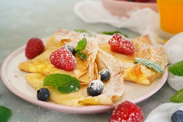 Fototapeta na wymiar Homemade Crepes with fresh fruits and berries, selective focus
