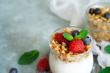 Healthy Breakfast Granola Yyogurt Parfait with fresh fruits and berries, selective focus