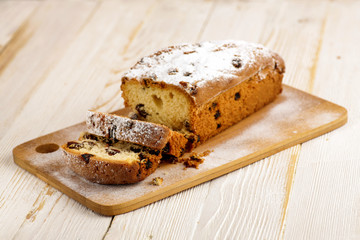 Delicious homemade cake with raisins on a light wooden background. close-up. rustic. copy space.