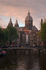 Fototapeta premium Church of Saint Nicholas dominating the main canal from Red Lights District at the center of Amsterdam, Holland, The Netherlands.