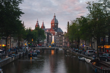 Obraz premium Church of Saint Nicholas dominating the main canal from Red Lights District at the center of Amsterdam, Holland, The Netherlands.