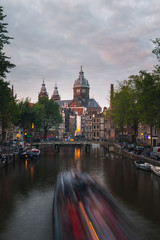Fototapeta premium Church of Saint Nicholas dominating the main canal from Red Lights District at the center of Amsterdam, Holland, The Netherlands.