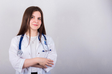 female doctor or nurse standing with stethoscope, medicine concept