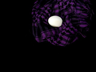 The egg lies in a scarf. Easter. Eggs in colored scarves.
