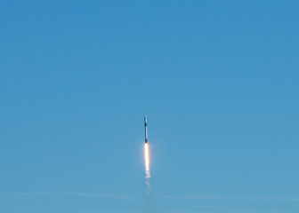 Naklejka na ściany i meble Rocket launch on a clear blue sky cloudless day.