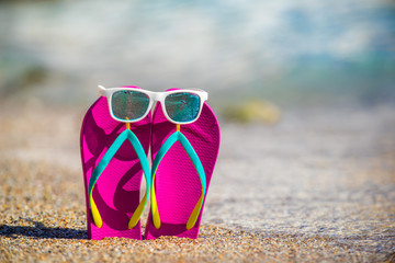 Flip-flops with sunglasses on beach
