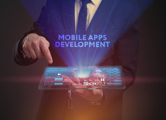The concept of business, technology, the Internet and the network. A young entrepreneur working on a virtual screen of the future and sees the inscription: Mobile apps development