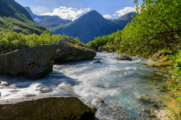 Fototapeta na wymiar Beautigul powerful Glacial river in summer Norway