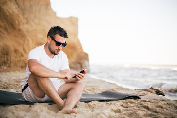 young woman talking with mobile phone on the beach