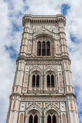 Fototapeta premium Italy,Florence, Giotto's Campanile, a large tall tower with a clock at the top of a stone building with Giotto's Campanile in the background