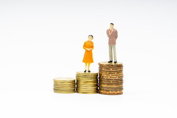 Miniature people standing on coins with white background. Business and Lifestyle concepts.