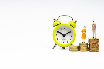 Kuala Lumpur, Malaysia - March 2, 2019 : Miniature people standing on coins with white background. Business and Lifestyle concepts.