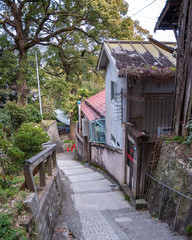 A narrow street on the slopes of Mt. Senkoji's Onomichi Cat Alley, or also known as "Neko no Hosomichi", where you can find lucky stone cats painted by local artist, Shunji Sonoyama.