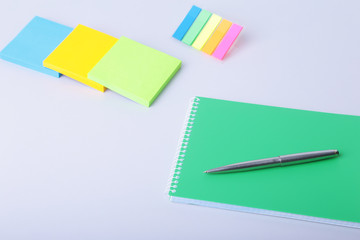 Business concept. Top view of kraft spiral notebook, glasses, smartphone and black pen isolated on background for mockup.