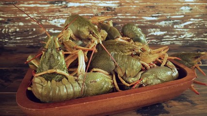 Live crayfish on a wooden table