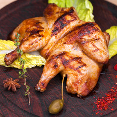 Roast chicken and leaf lettuce on a wooden board