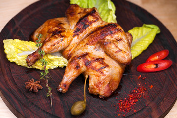 Roast chicken and leaf lettuce on a wooden board