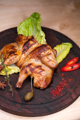 Roast chicken and leaf lettuce on a wooden board