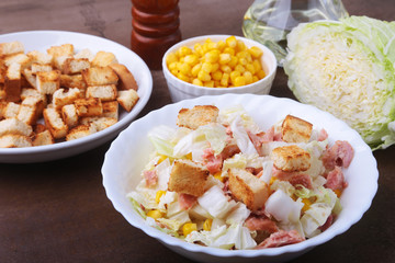 Fresh Chinese cabbage, Sweet canned corn, Delicious crispy croutons and canned tuna. Ingredients for dietary salad.