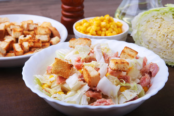 Fresh Chinese cabbage, Sweet canned corn, Delicious crispy croutons and canned tuna. Ingredients for dietary salad.