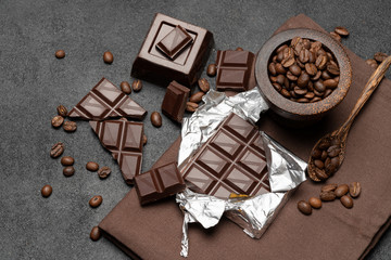 dark organic chocolate and coffee beans on concrete background