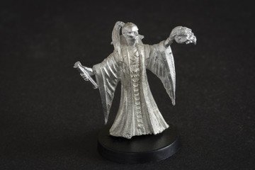 Tin figure of a magician with a crossbow.