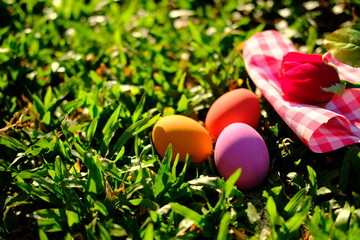 Happy easter eggs on grass of sunset
