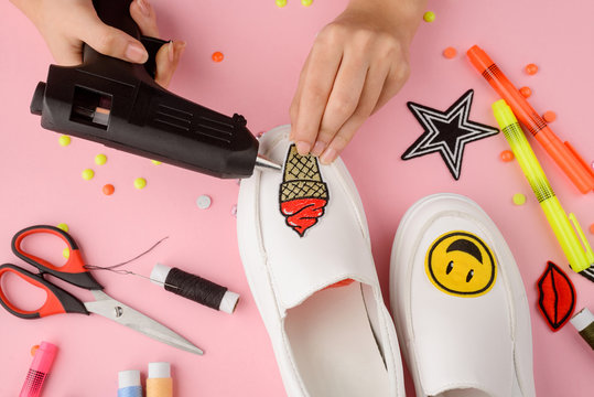 Girl applying patches to shoes