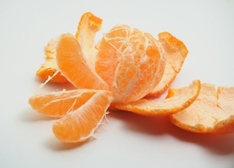 Mandarin is cleared from the skin. Fruit on white background.